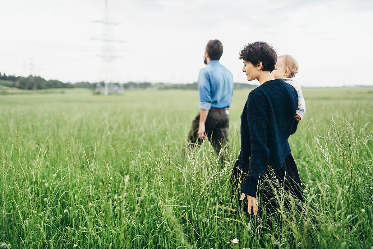 Beautiful family walking through the field