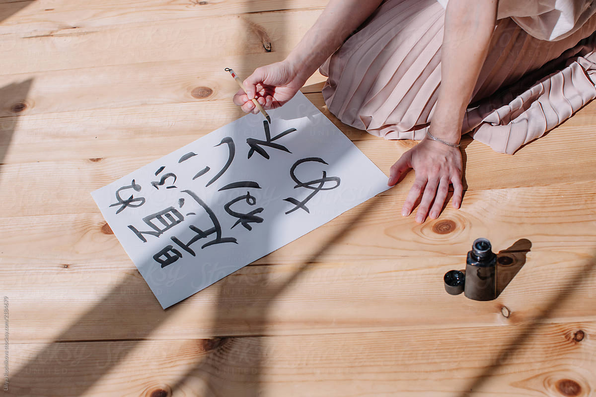 Unrecognizable female creating calligraphy