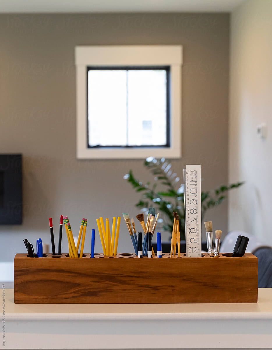 Pencils and pens in design studio in home office with window
