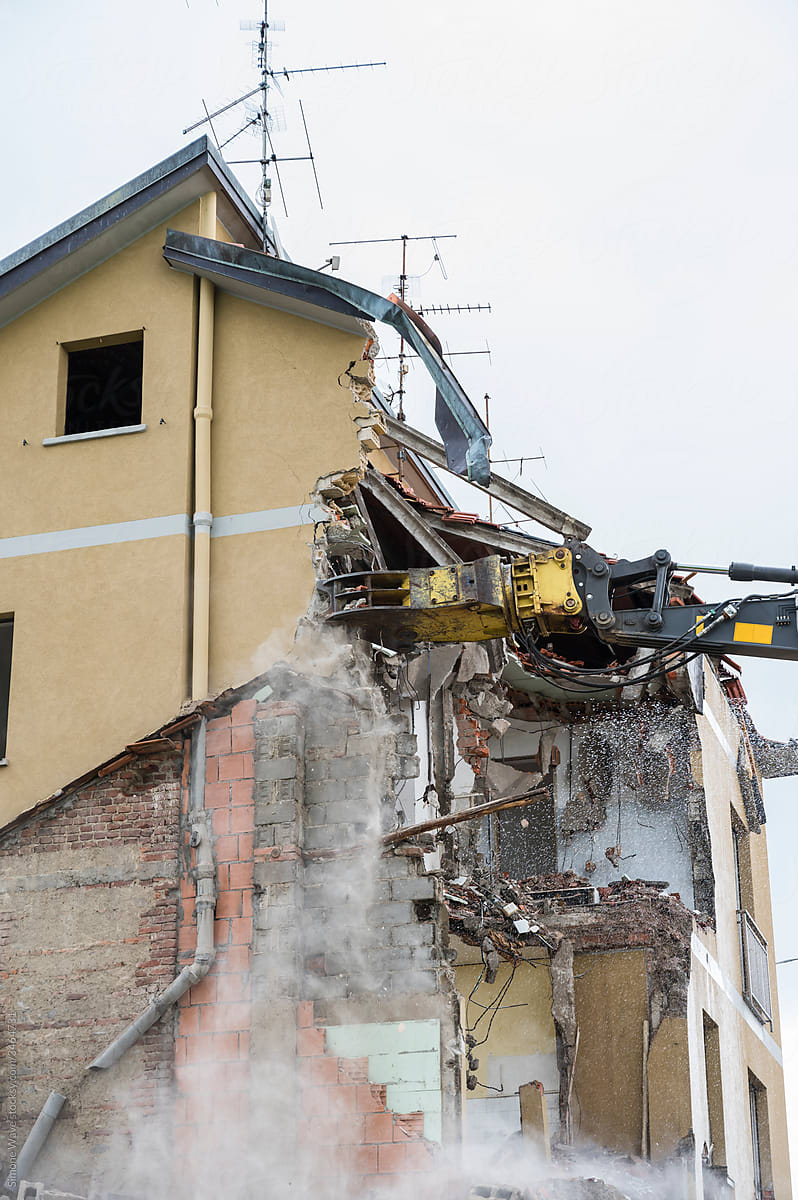 Crusher excavator machine during house demolition