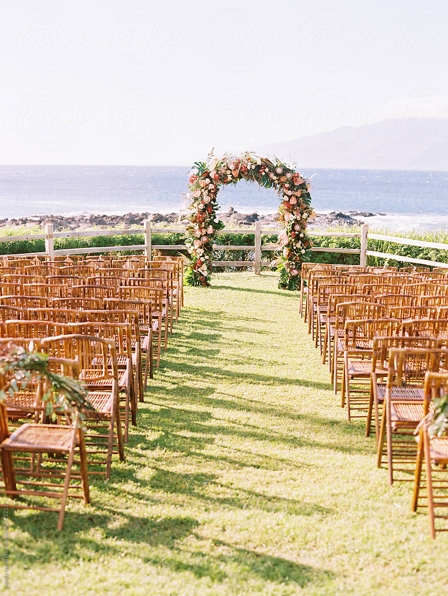 Flowered wedding arch on cliff over ocean