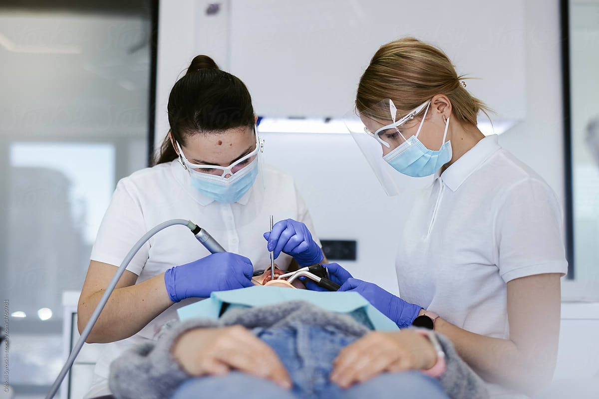 Dentists during dental intervention with client
