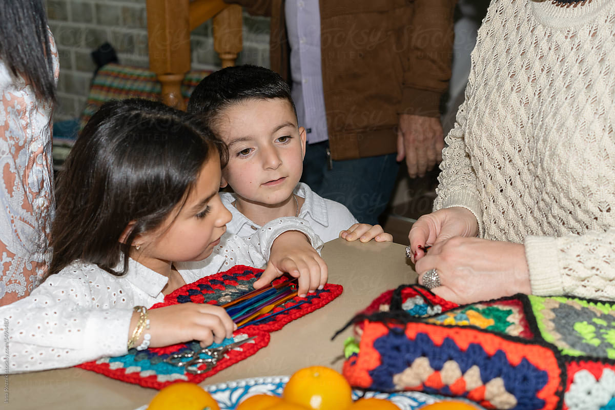 Enthusiastic Children Watch Grandma\'s Knitting Magic.