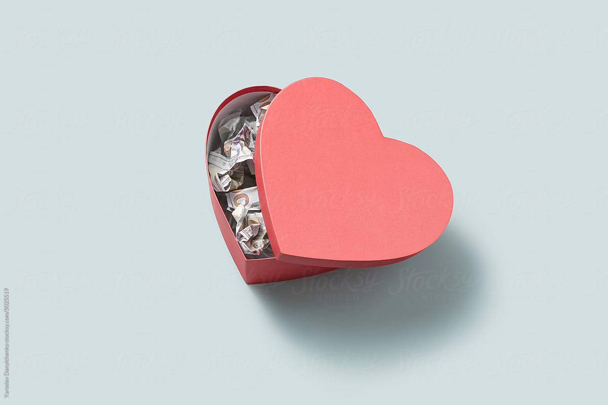 Creasy 100 dollar bills inside heart-shaped box.