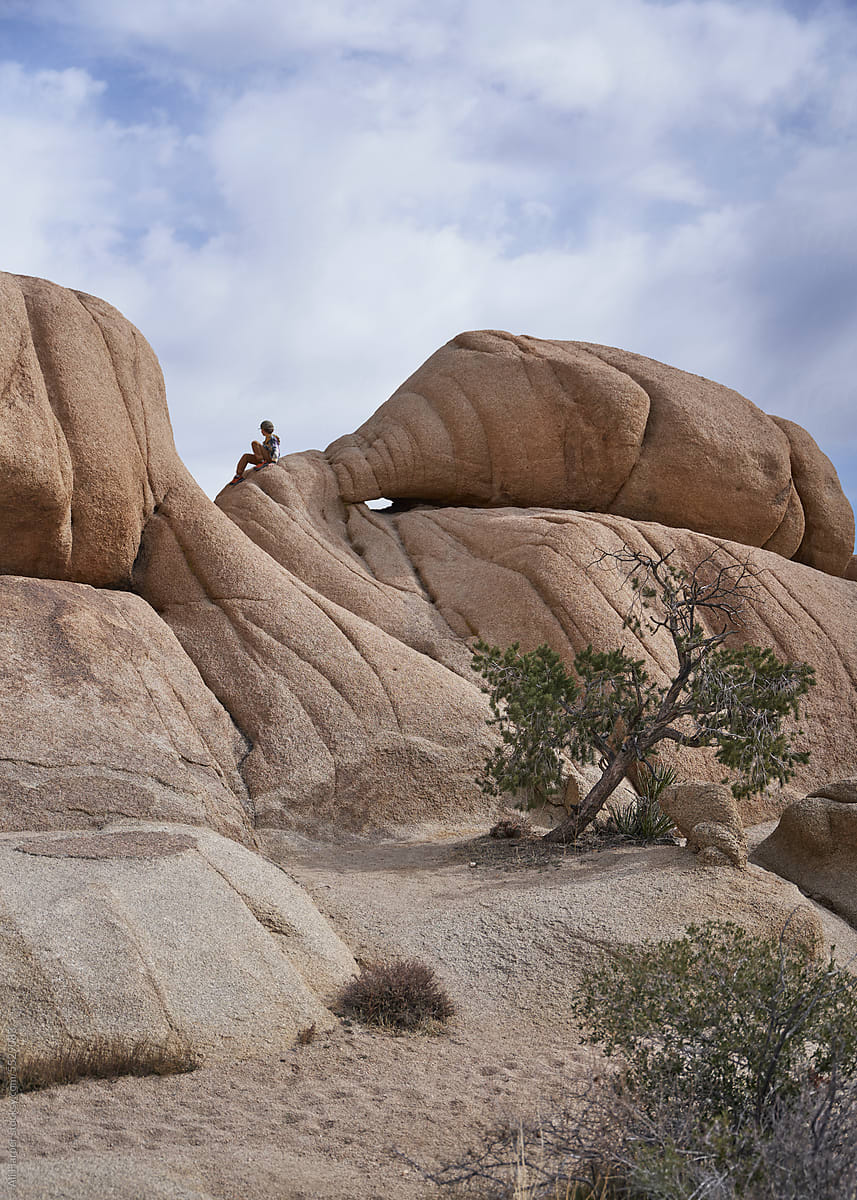 Little boy atop a large rock formation in Joshua Tree National Park