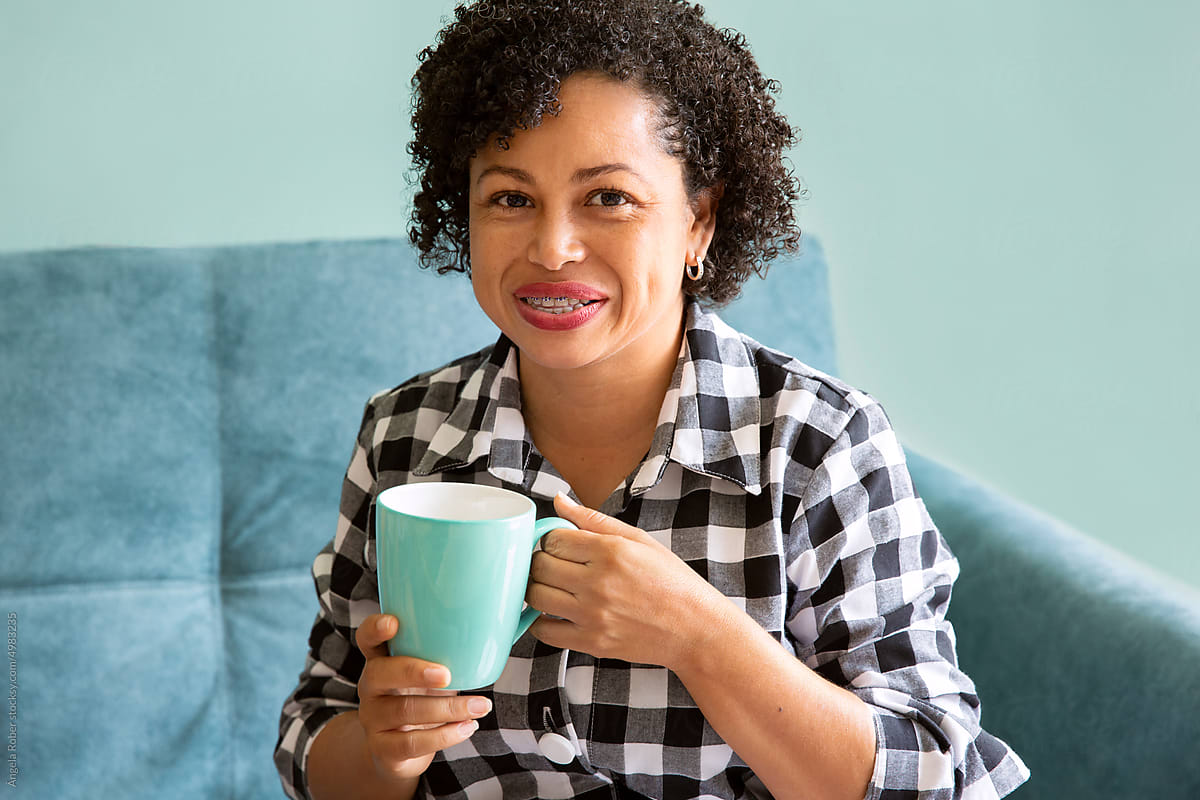 Portrait of a smiling woman with a cup of coffee