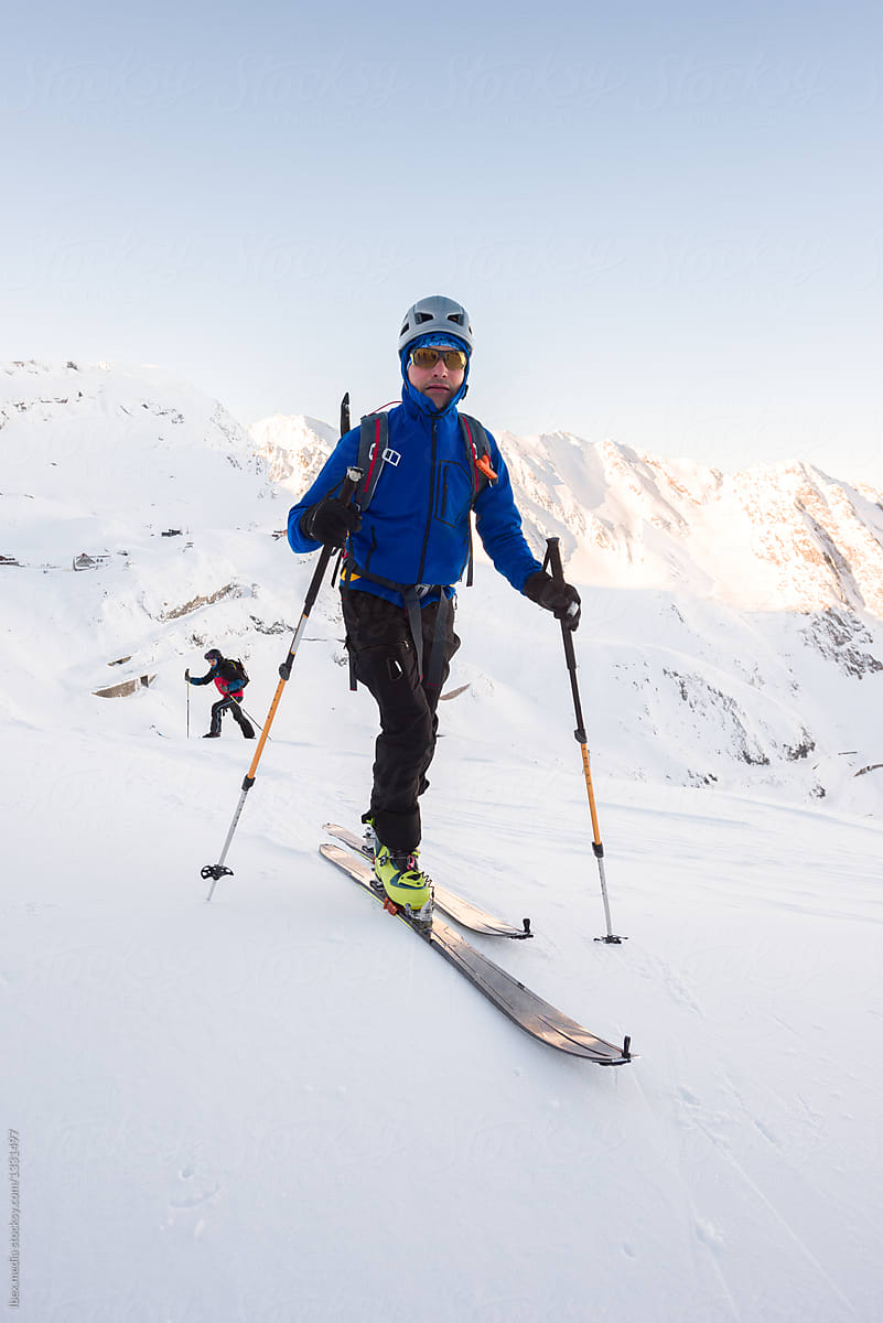 Portrait of man ski touring along mountain plateau