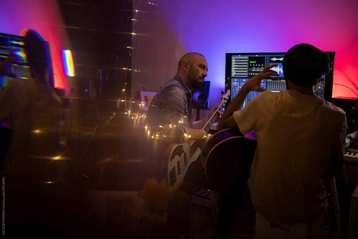 Musicians producing music in home recording studio