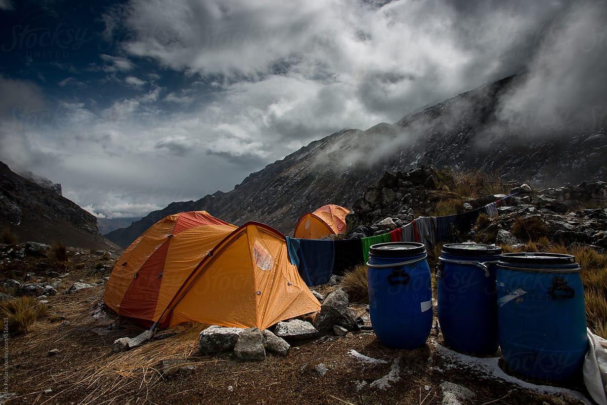 Tent and camp in the mountains with moody clouds