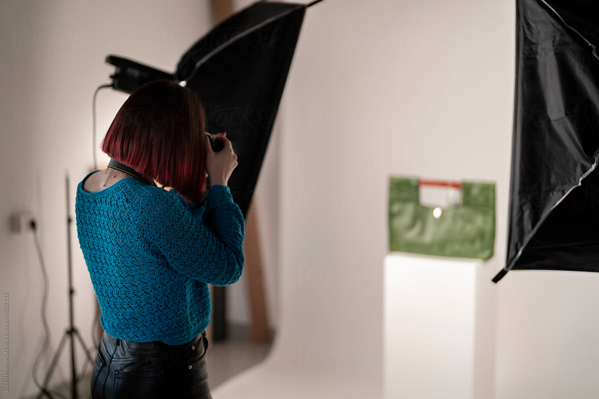 Unrecognizable woman taking photo of leather product