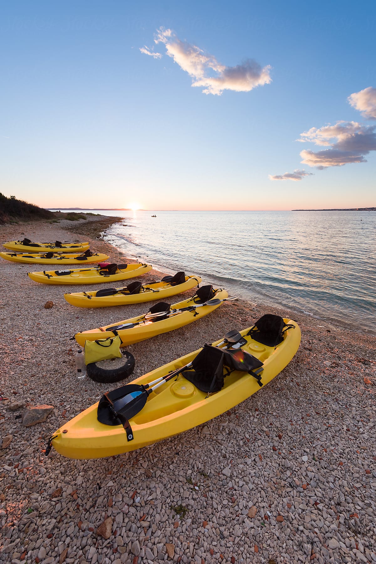Yellow kayaks alligned on the seashore