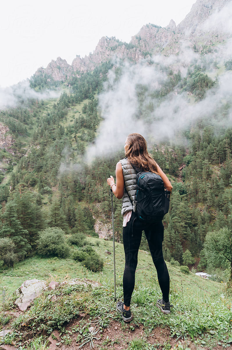 Young female backpacker enjoying mountainous landscape