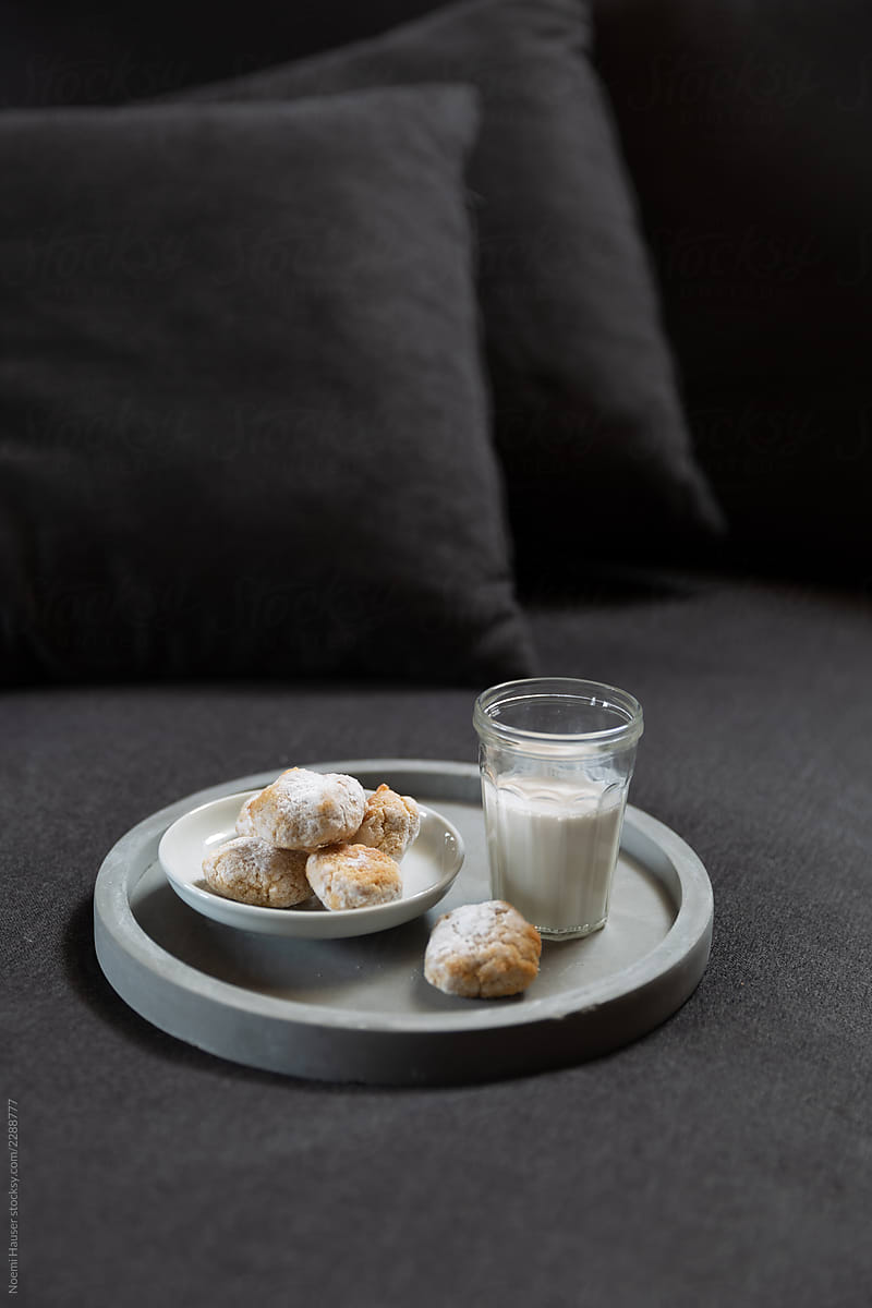 Almond cookies with almond milk on cozy sofa