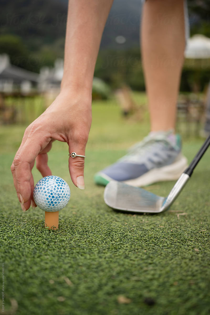 Golfer Placing Golf Ball on Tee