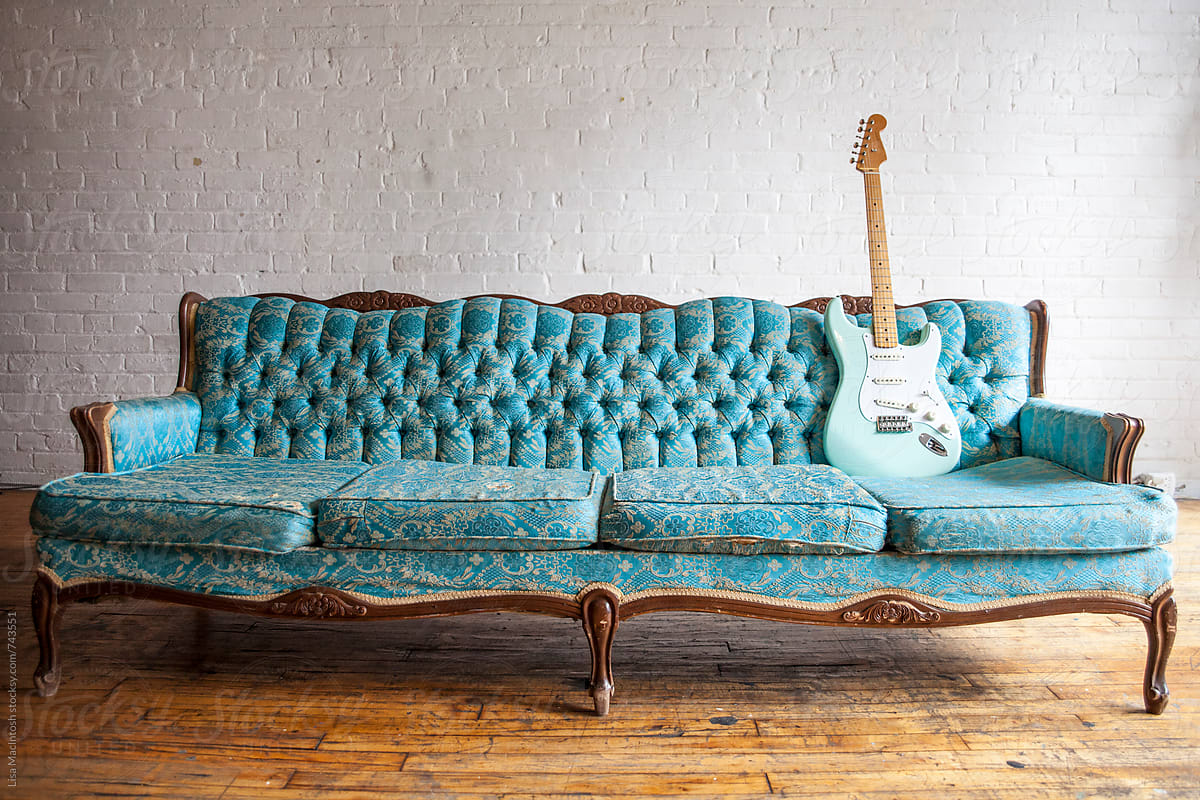 vintage blue couch with vintage blue guitar