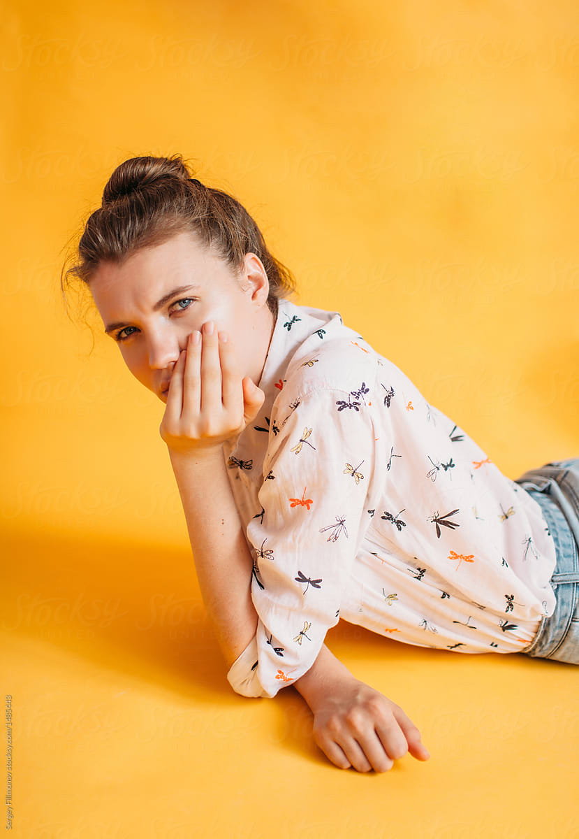 Portrait of teen model on yellow background