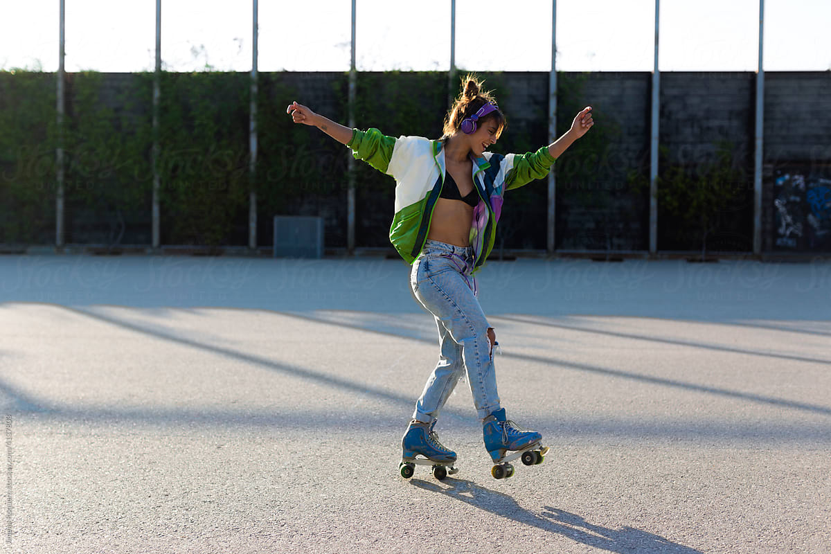 Roller-skater girl dancing joyfully in sunlight