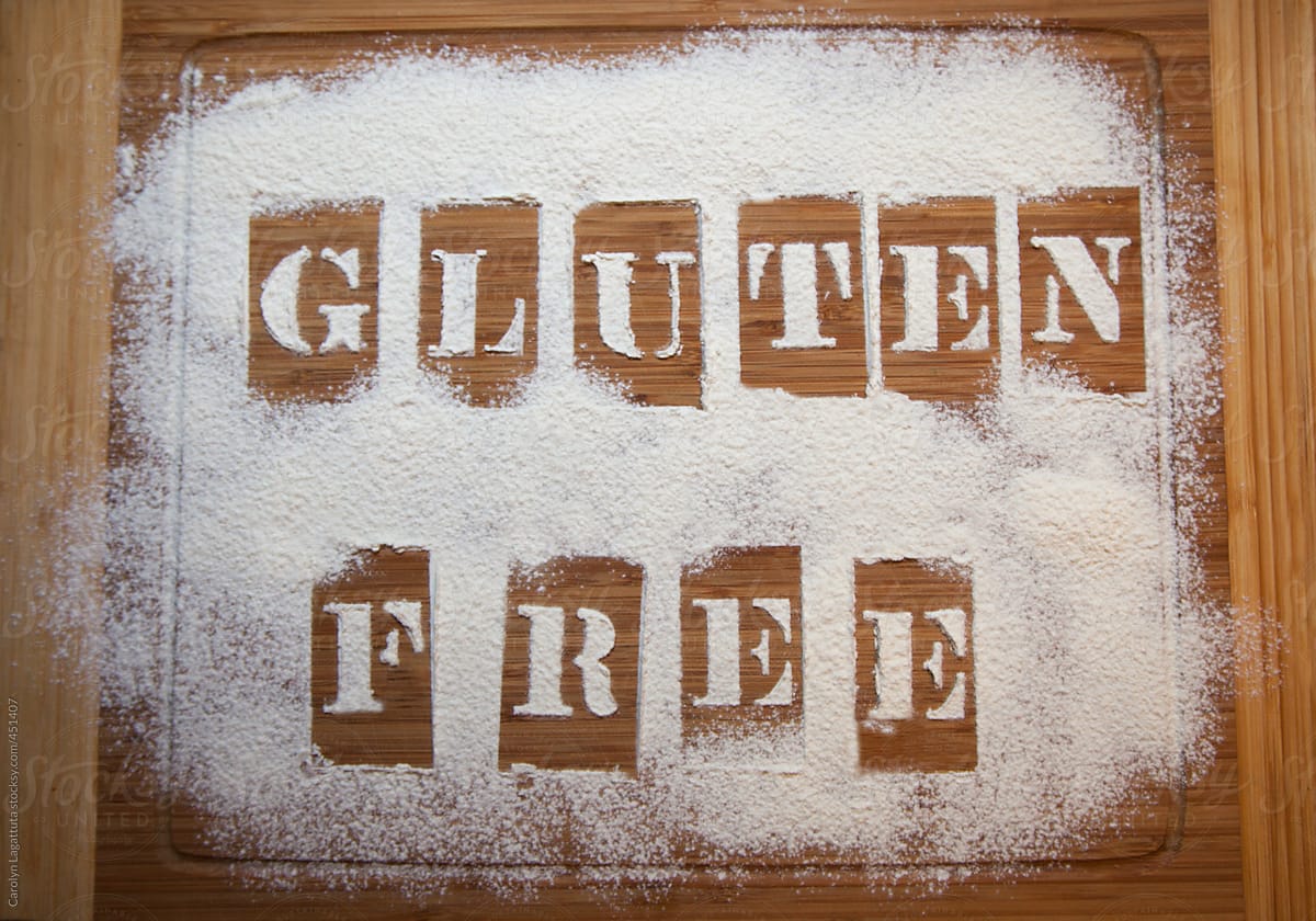 Cutting board with a message that says Gluten Free in sifted flour