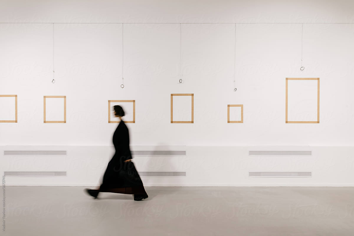 defocused woman walking in exhibition art hall