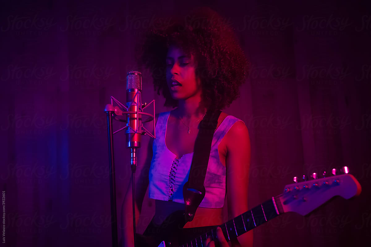 Black Girl Singing And Playing The Guitar In The Studio