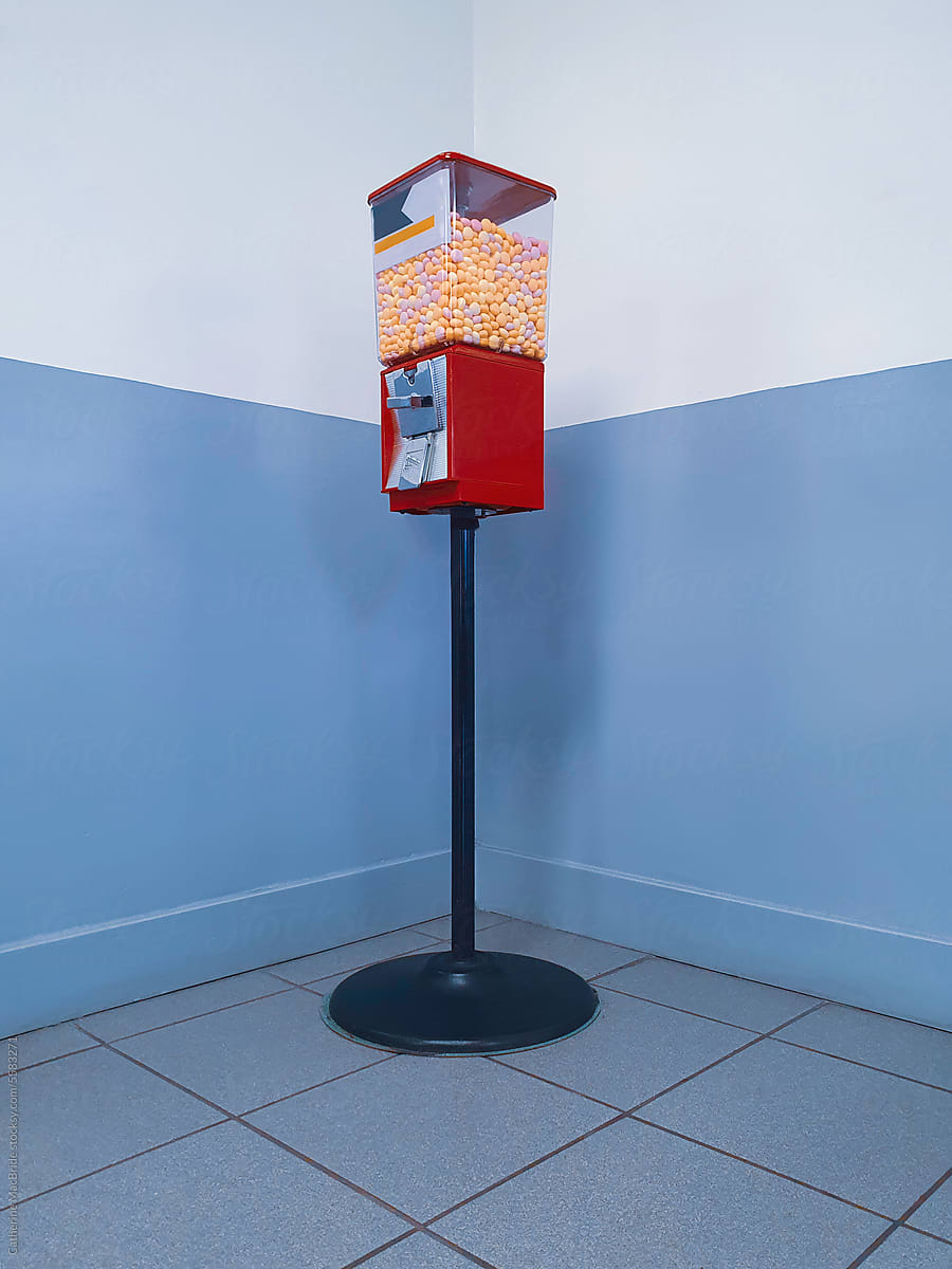 A candy dispenser in a corner
