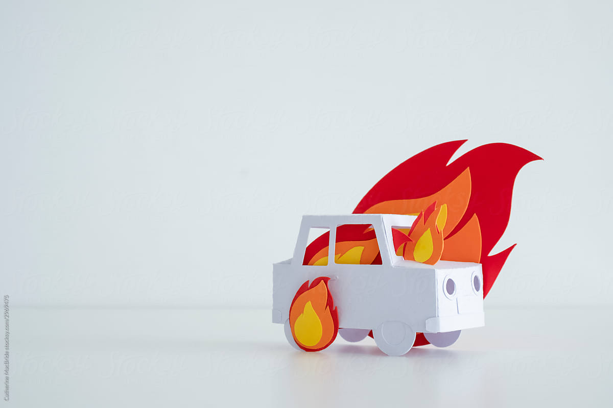 Stock photo of paper craft car on fre with bright paper flames