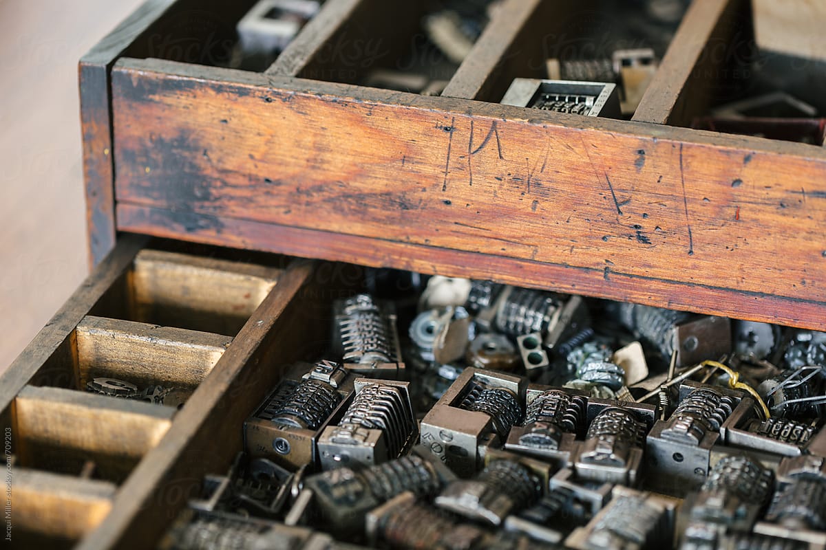Close up of old wood drawer filled with vintage metal numbering inserts for printer