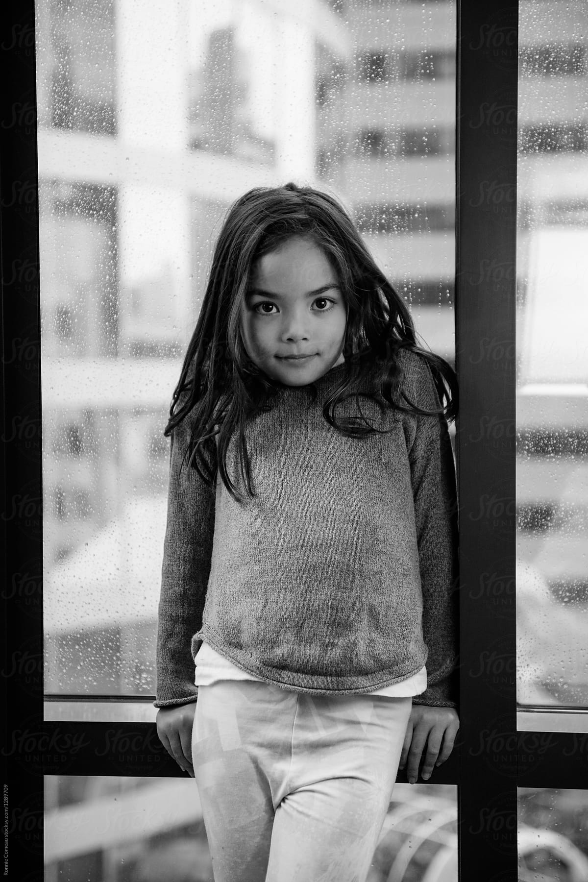 Eurasian Girl Standing By Window Del Colaborador De Stocksy Ronnie Comeau Stocksy
