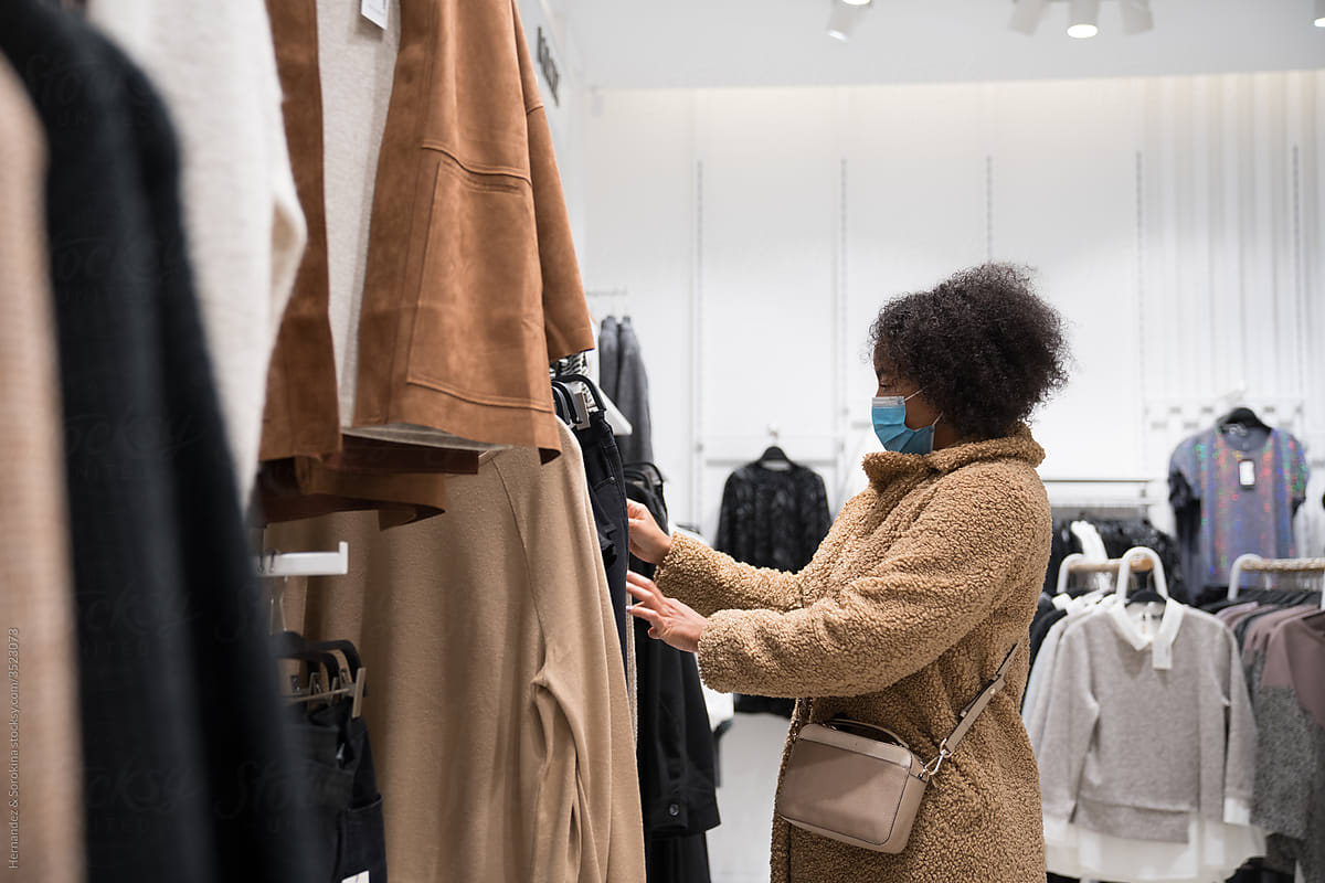 Woman With Protective Mask At Clothes Shop