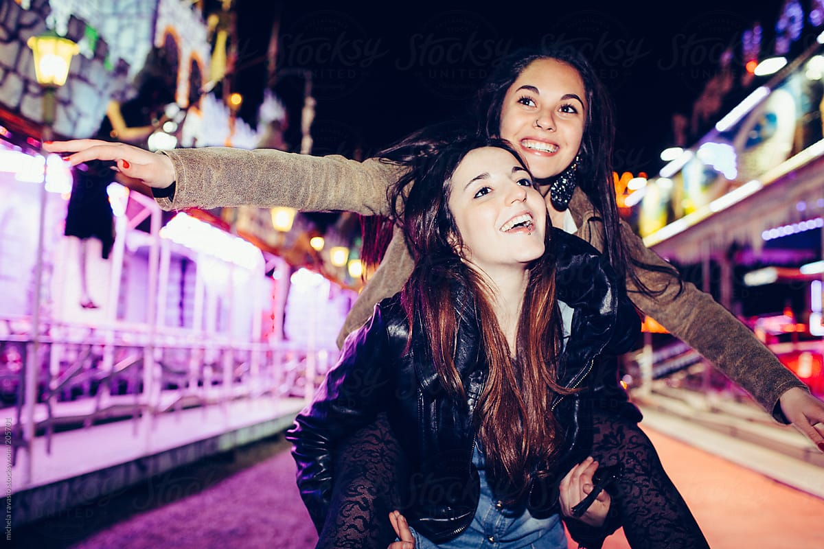 Two Girls Friends At The Carnival Del Colaborador De Stocksy Michela