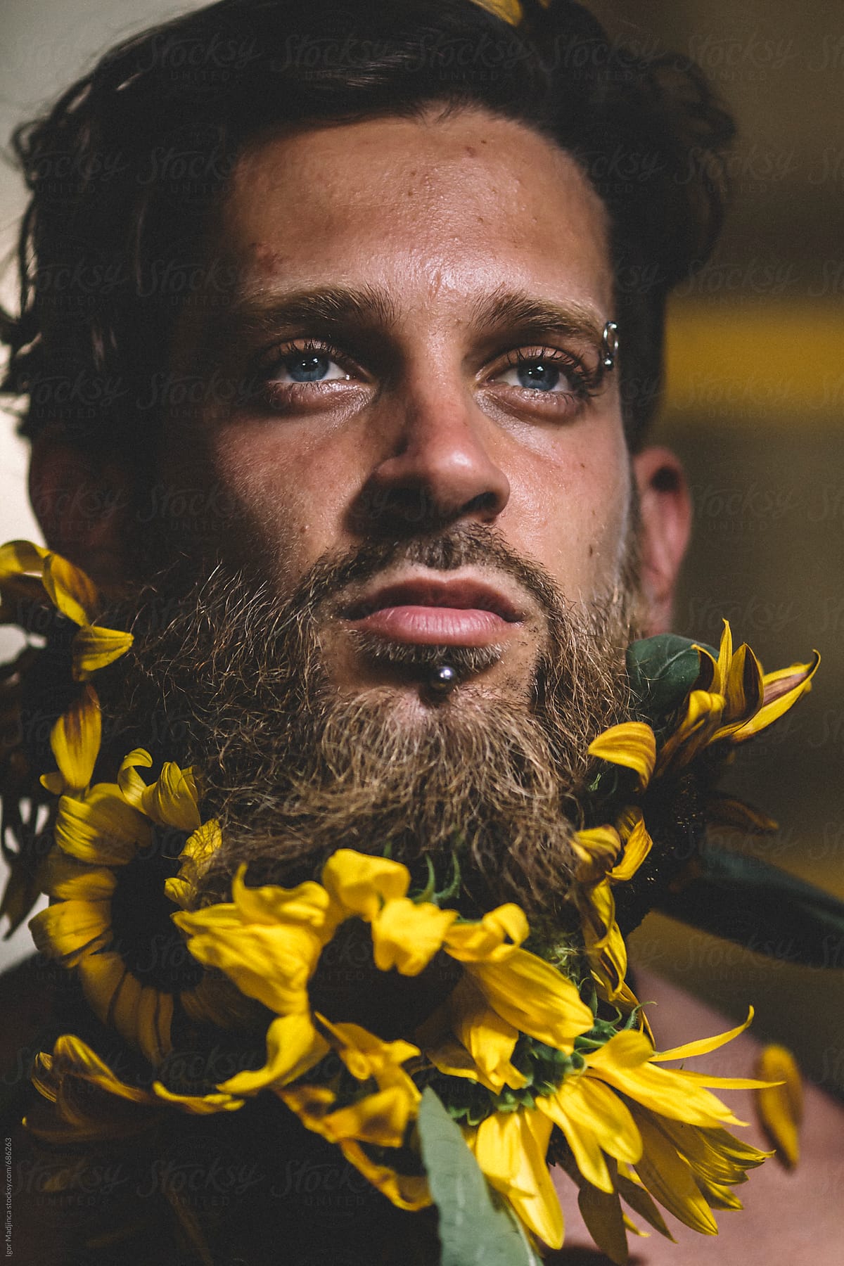 Portrait of young hipster men with sunflowers