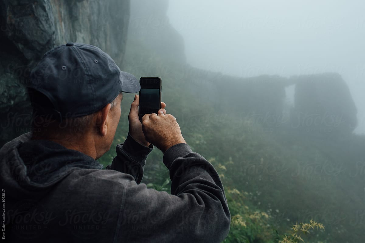 Middle Age Man Taking Photo with Phone While Hiking
