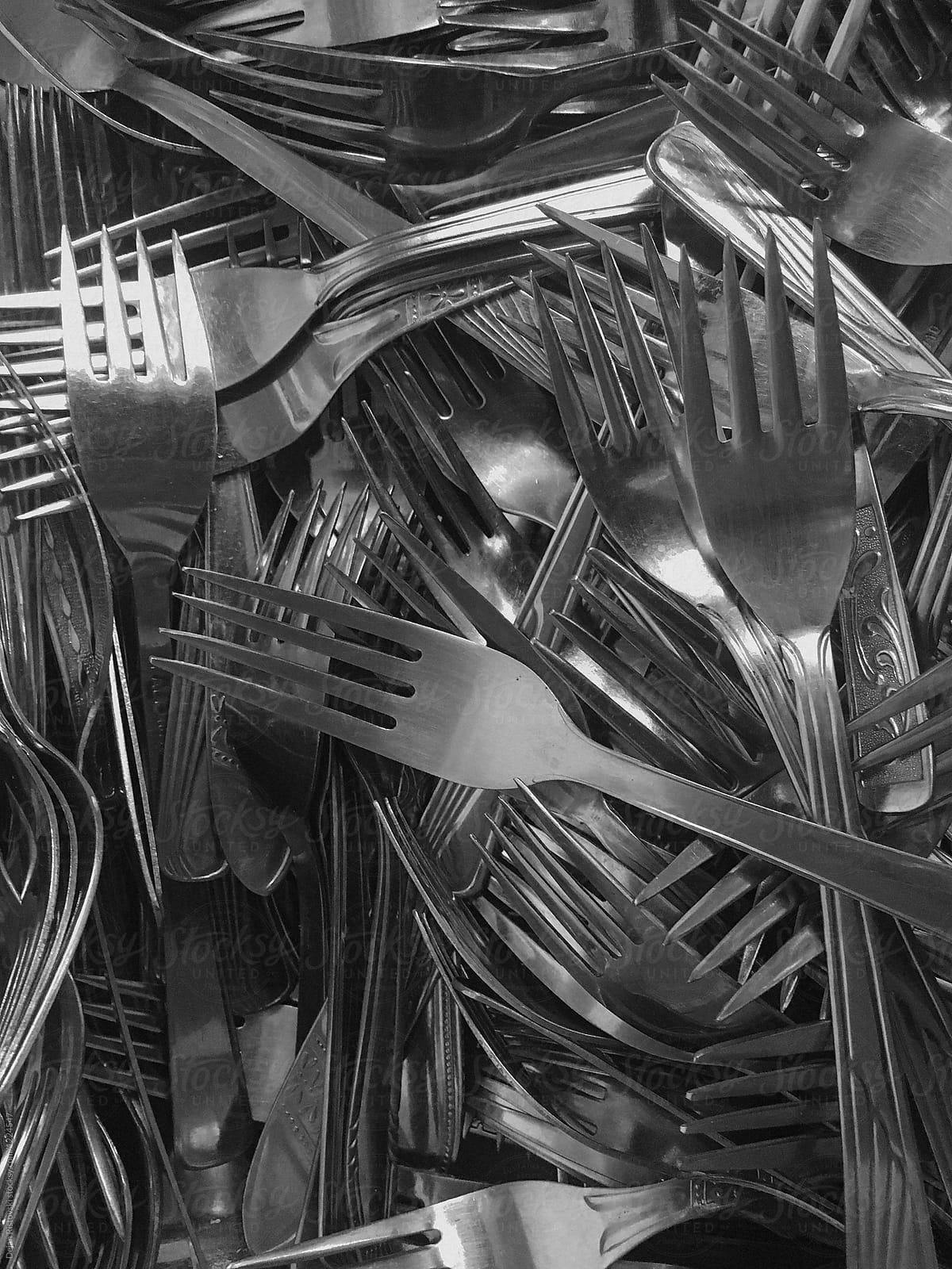 A bunch of forks in a drawer.