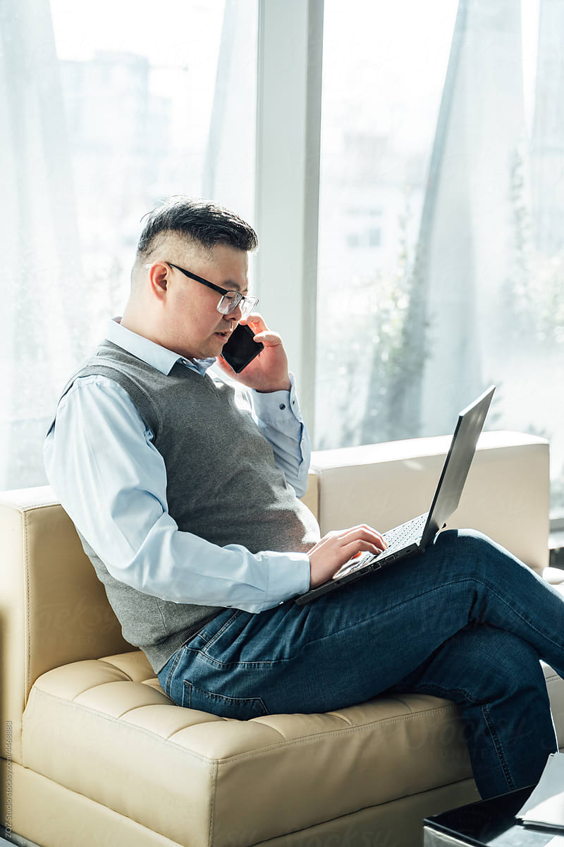 Chinese businessman using laptop