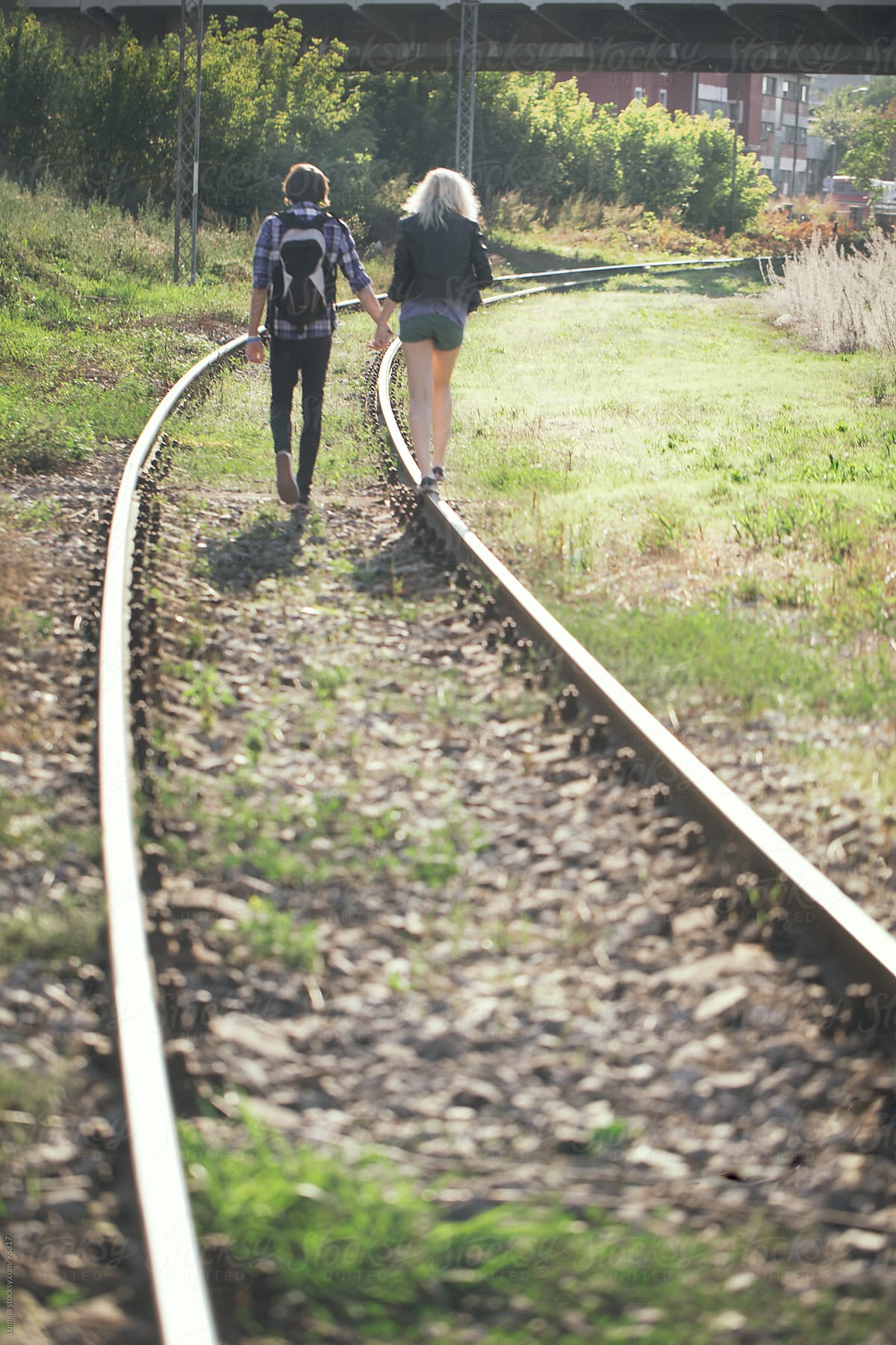 Teenage Couple On The Railway By Stocksy Contributor Lumina Stocksy