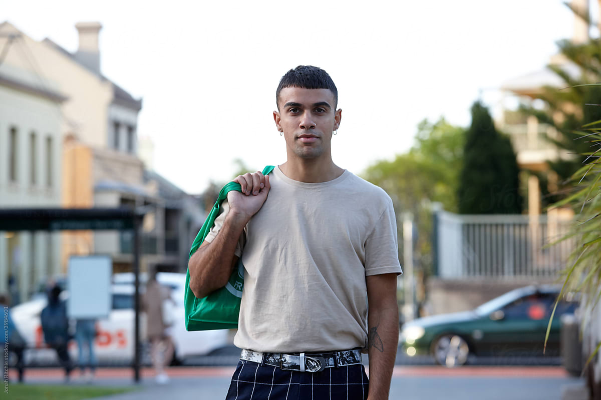 Young Indigenous Australian man holding reusable shopping bag