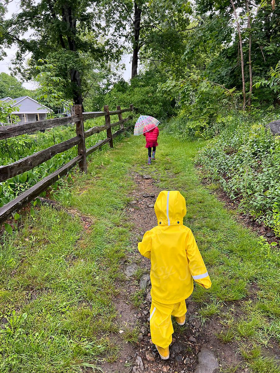 Kids with Rain Gear Walking Outside in the Rain
