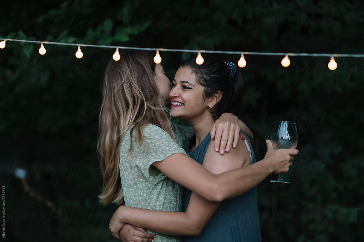 Women Hug each other at a Backyard Dinner Party
