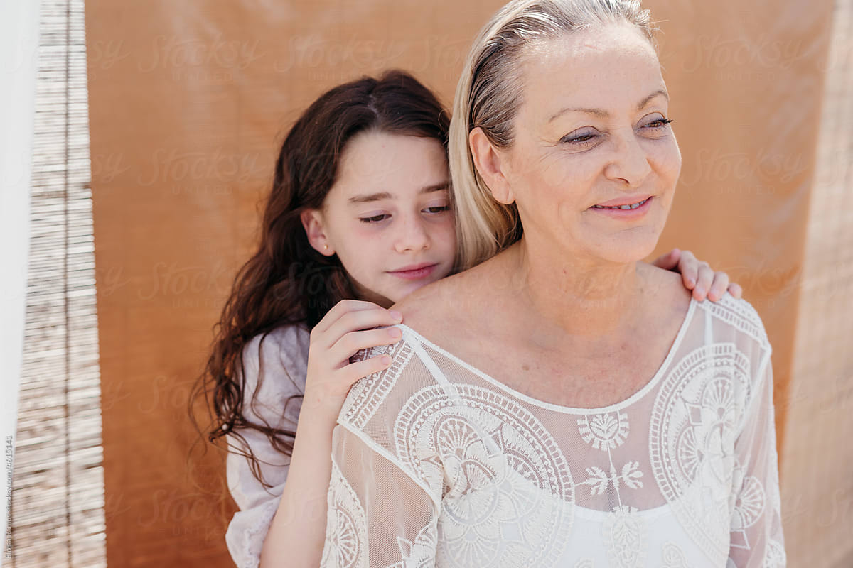 Grandmother and granddaughter embracing outdoors portrait