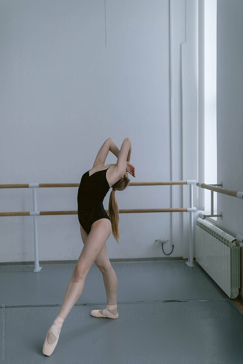 Ballerina rehearsing and completing hard movements