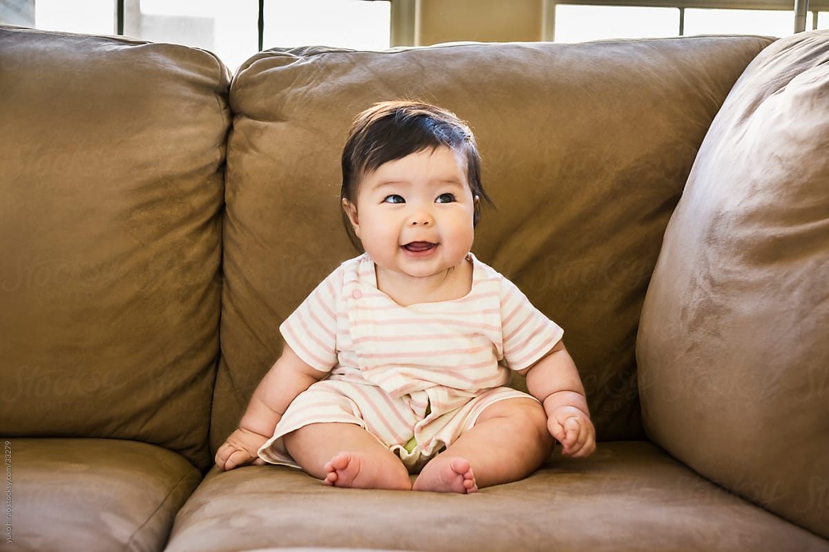 Happy baby girl on a couch