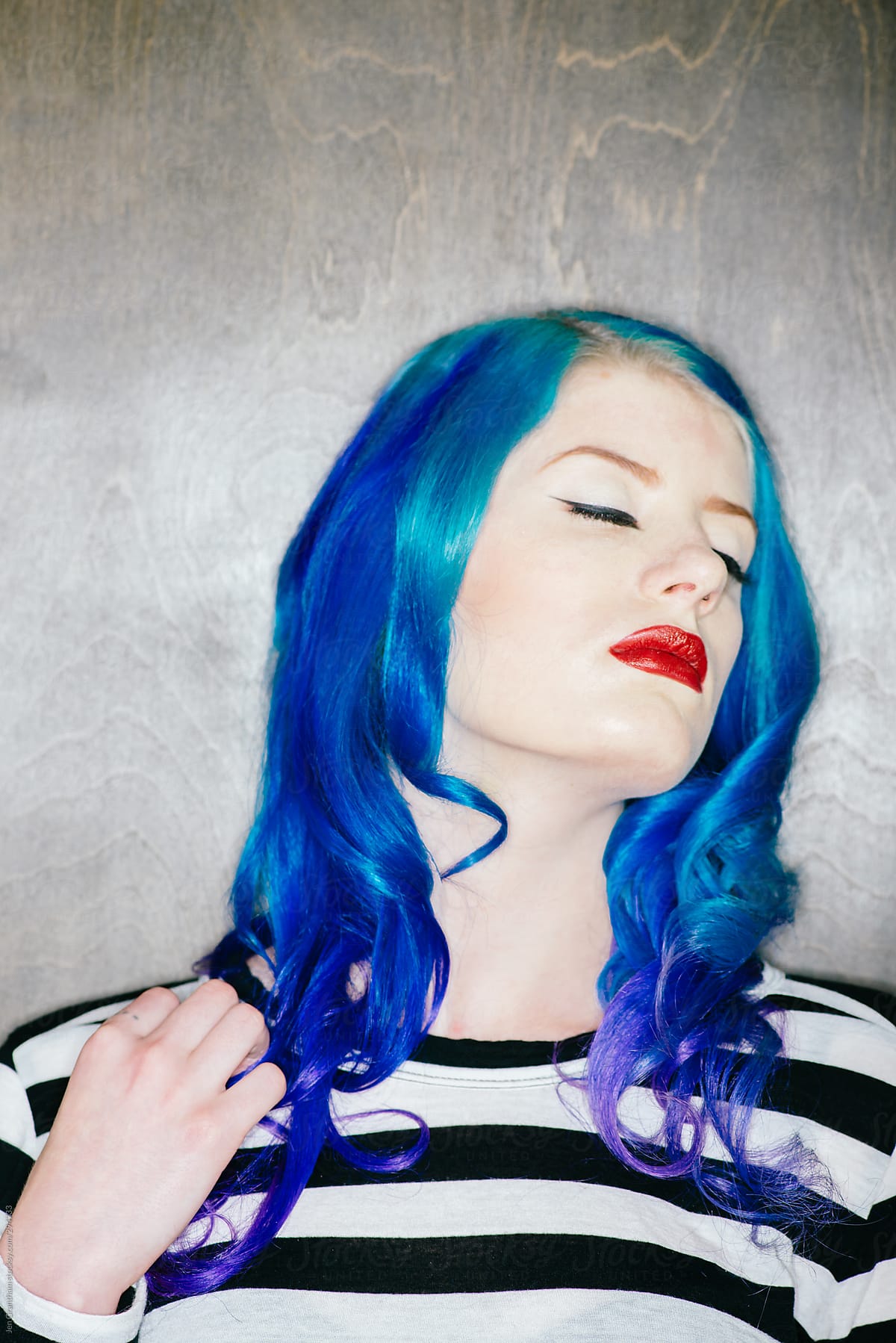 Model with blue hair in harsh light
