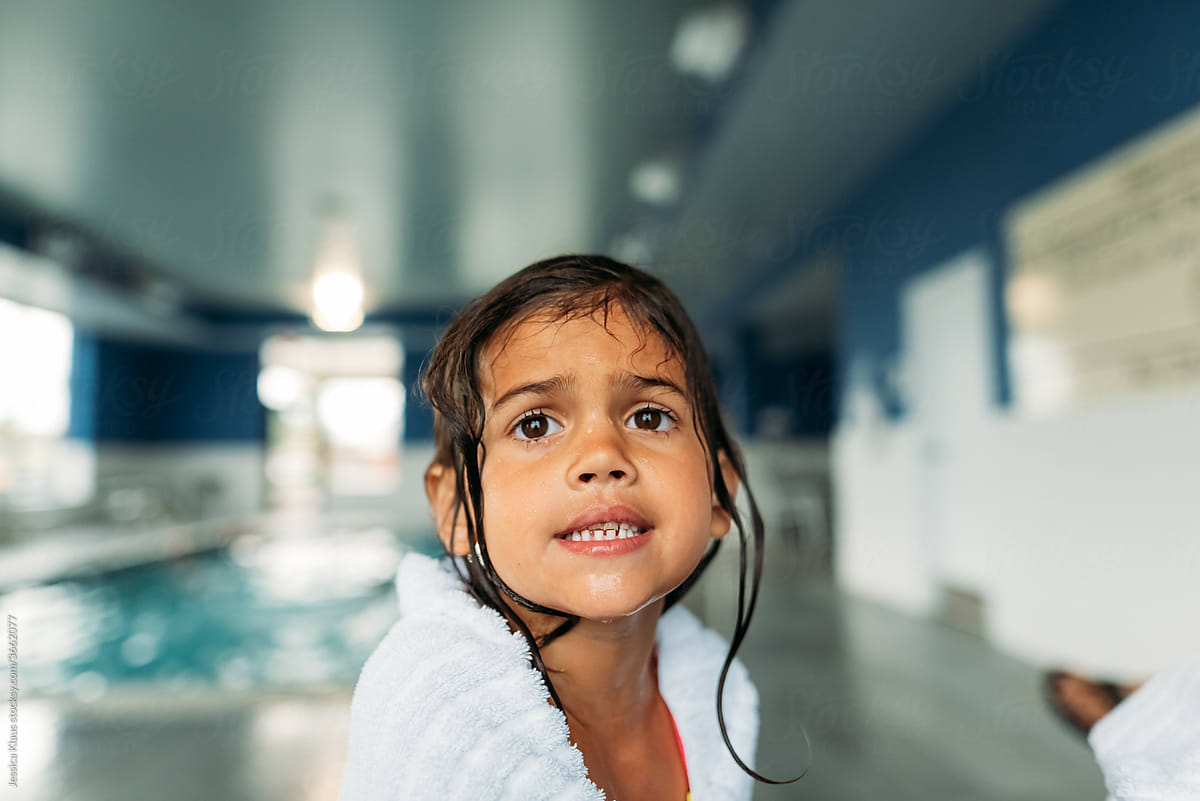 Girl whining at indoor swimming pool.