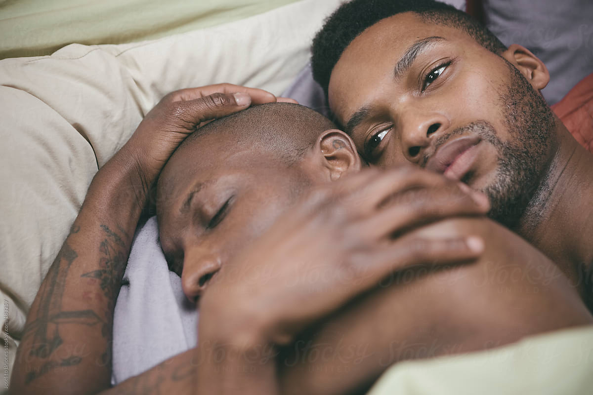 Black Gay Man in Reflective Mood Holding his Lover in Bed by Joselito Brion...