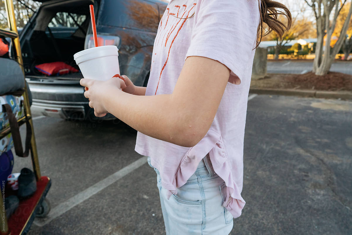Person holding a styrofoam cup.