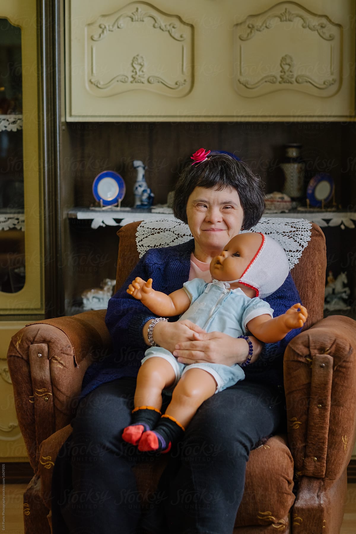 Woman With A Down Syndrome Holding A Doll