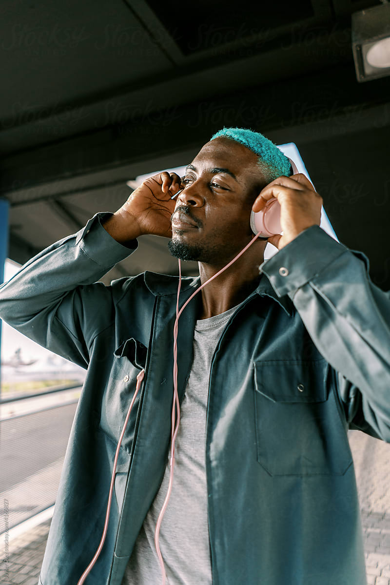 Black man listening to music in headphones