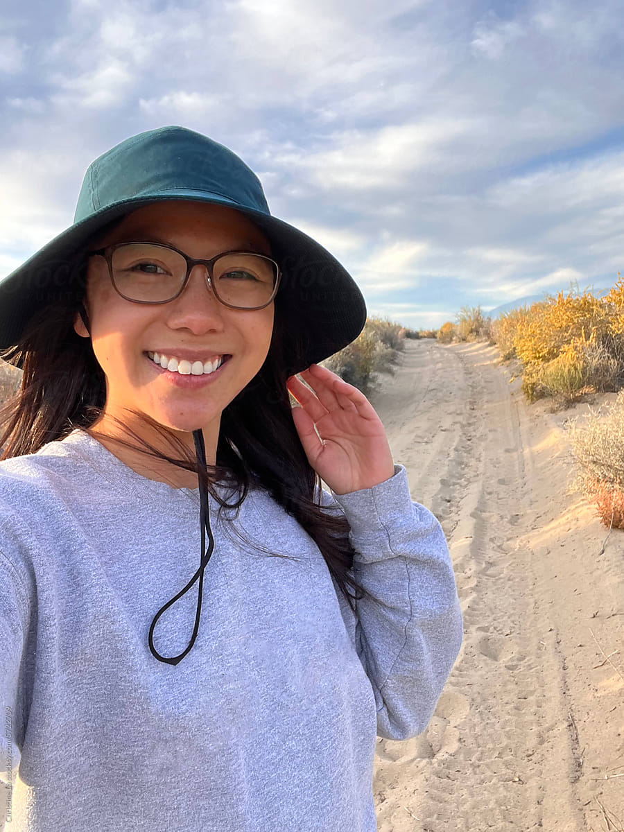 UGC selfie of smiling woman on a hike