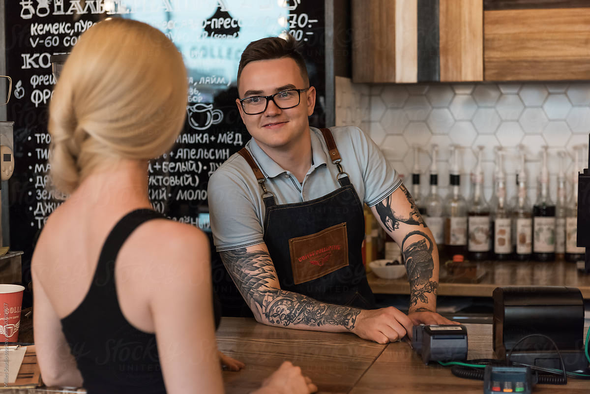 Smiling barista taking order of client