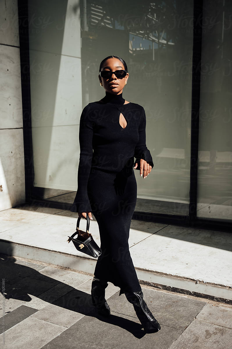 Woman wearing black dress walking